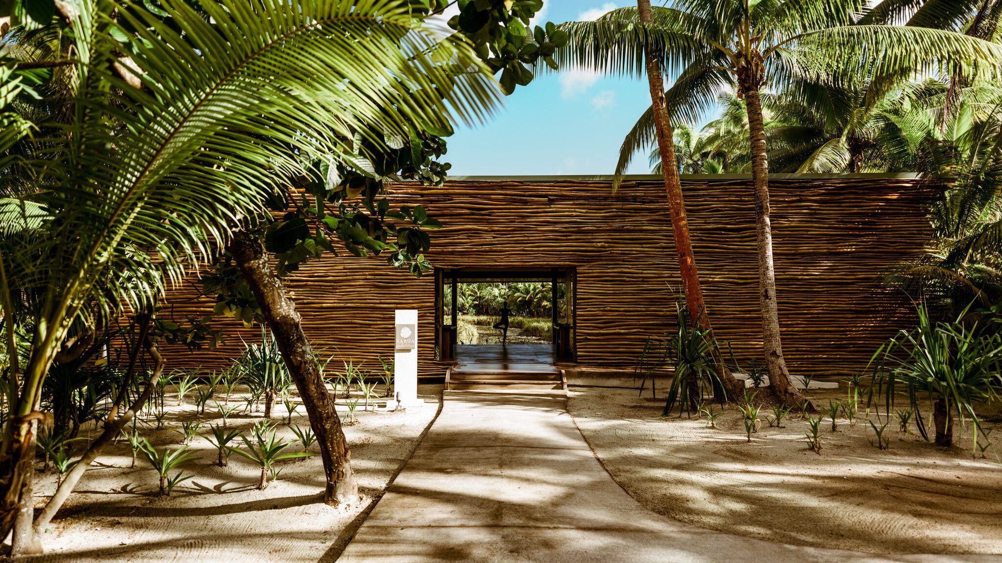 Woman doing yoga in a building with a branch exterior at our Tahiti spa