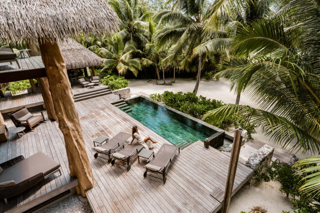 Woman relaxing on a secluded pool deck at our private island resort